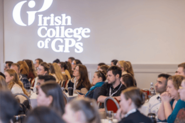Irish College of GPs branded wall with trainees at conference